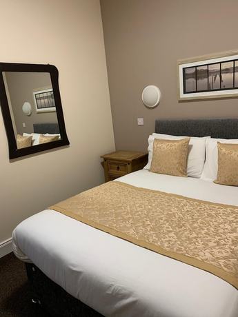 Imagen de la habitación del Hotel The Royal Guesthouse. Foto 7