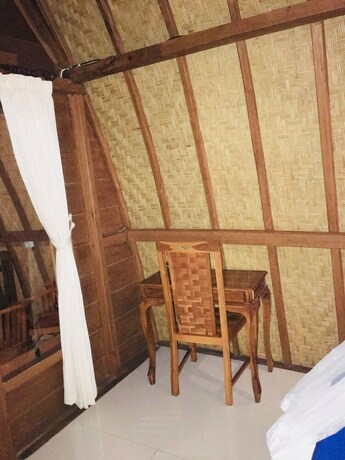 Imagen de la habitación del Hotel The Sandat Bungalow. Foto 31