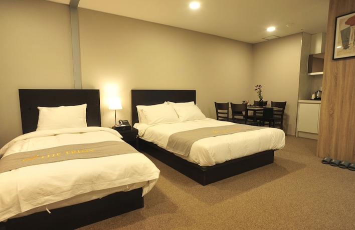 Imagen de la habitación del Hotel The Triny Urban Suites. Foto 12