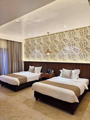Imagen de la habitación del Hotel The Tropics at MacArthur Park Resort and Convention Center. Foto 3