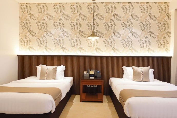 Imagen de la habitación del Hotel The Tropics at MacArthur Park Resort and Convention Center. Foto 4