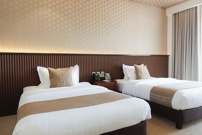 Imagen de la habitación del Hotel The Tropics at MacArthur Park Resort and Convention Center. Foto 10