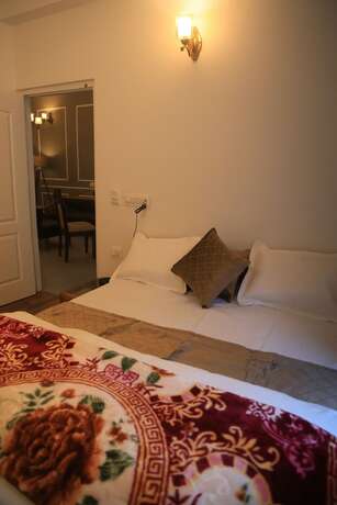 Imagen de la habitación del Hotel The Whispering Pine And Suites. Foto 17