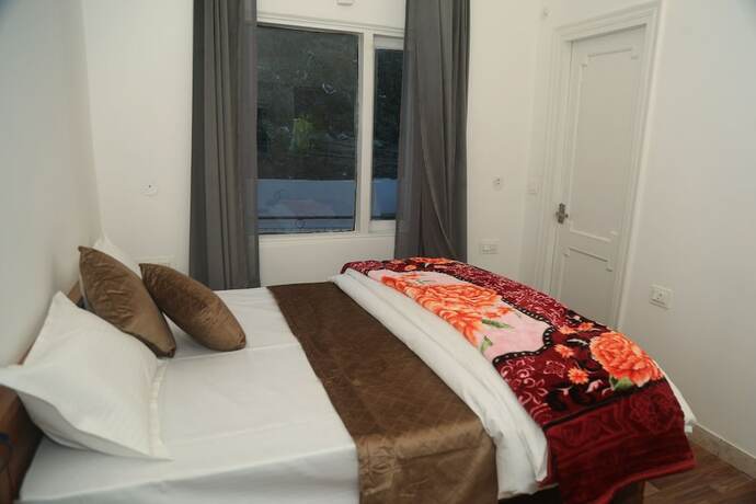 Imagen de la habitación del Hotel The Whispering Pine And Suites. Foto 18