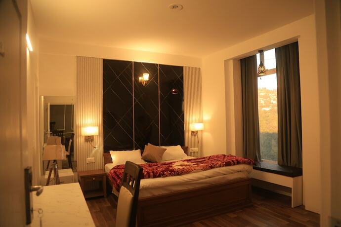 Imagen de la habitación del Hotel The Whispering Pine And Suites. Foto 21