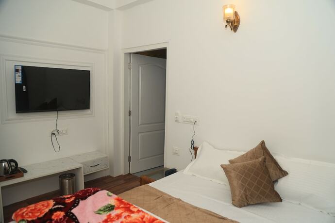 Imagen de la habitación del Hotel The Whispering Pine And Suites. Foto 22