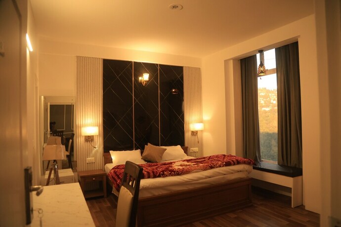 Imagen de la habitación del Hotel The Whispering Pine And Suites. Foto 24