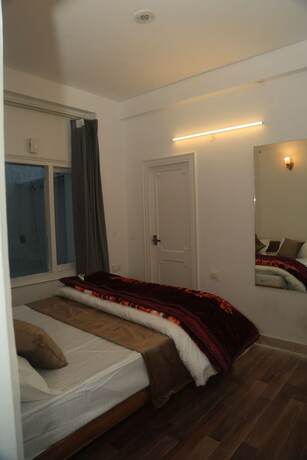 Imagen de la habitación del Hotel The Whispering Pine And Suites. Foto 27