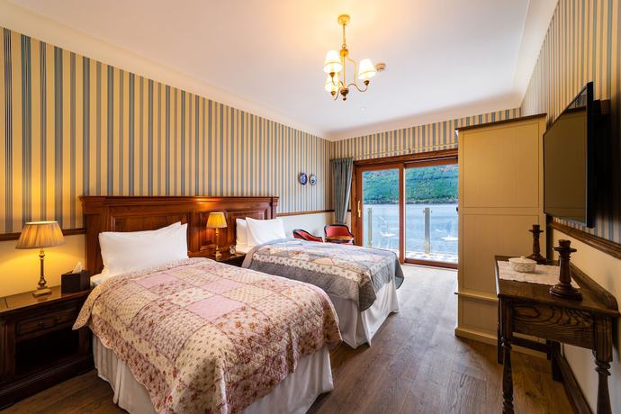 Imagen de la habitación del Hotel The Whispering Pine Lodge. Foto 14