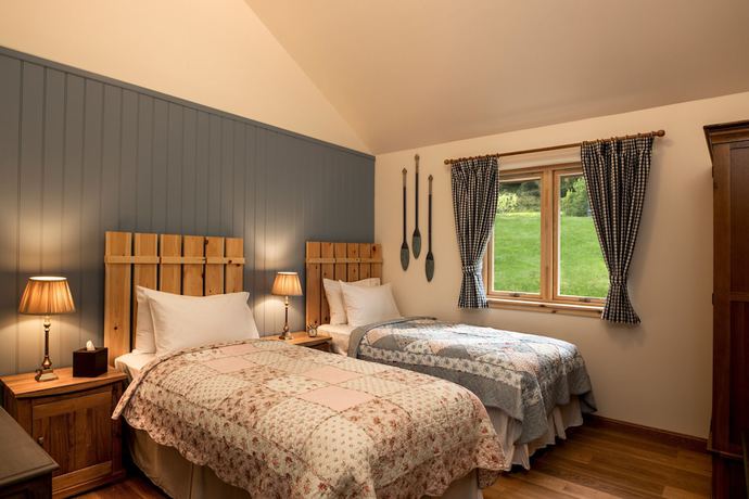 Imagen de la habitación del Hotel The Whispering Pine Lodge. Foto 15