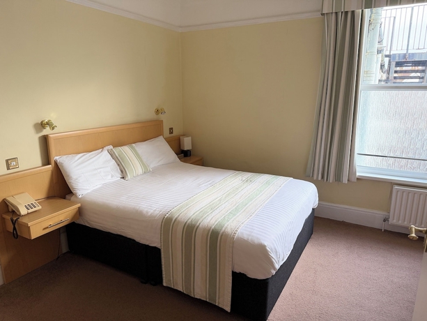 Imagen de la habitación del Hotel The Windsor House. Foto 10