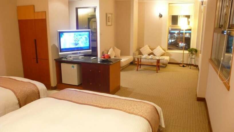 Imagen de la habitación del Hotel Tian Long. Foto 19