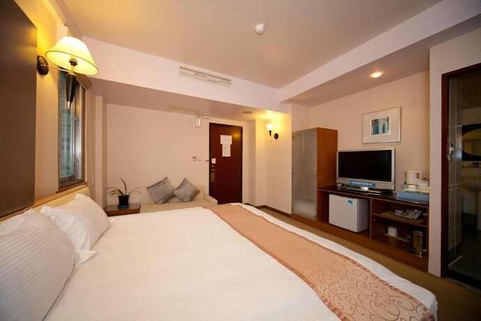 Imagen de la habitación del Hotel Tian Long. Foto 23