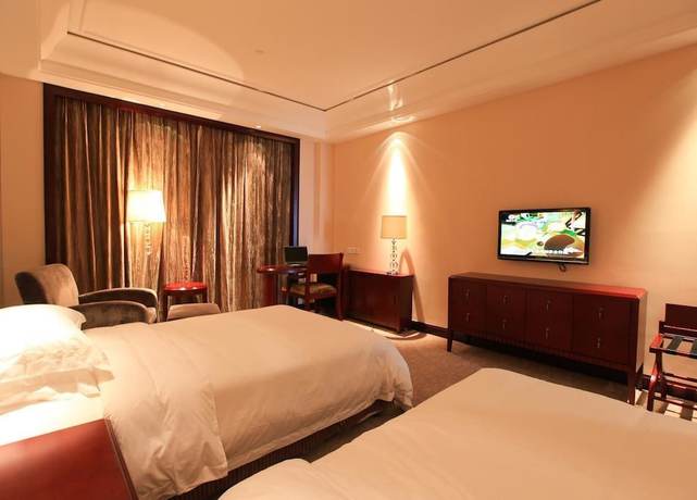 Imagen de la habitación del Hotel Tianbao Garden Hotel. Foto 7