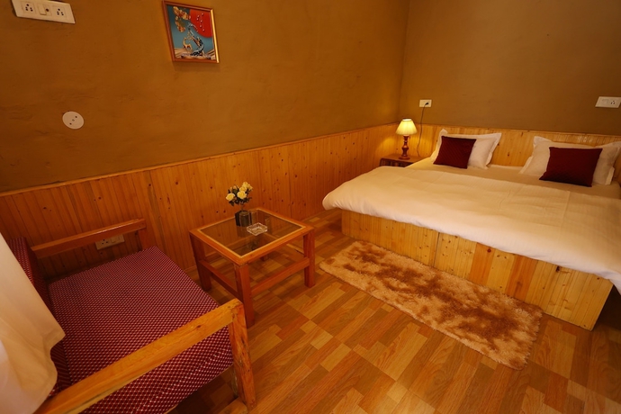 Imagen de la habitación del Hotel Tirthan Village Resort. Foto 7