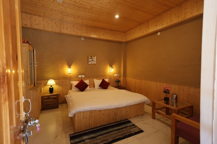 Imagen de la habitación del Hotel Tirthan Village Resort. Foto 9