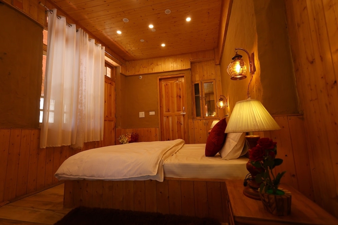 Imagen de la habitación del Hotel Tirthan Village Resort. Foto 11