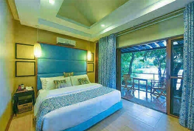 Imagen de la habitación del Hotel Tugawe Cove Resort. Foto 3