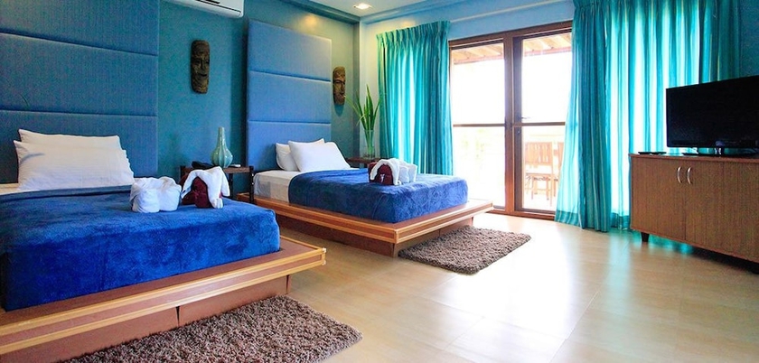 Imagen de la habitación del Hotel Tugawe Cove Resort. Foto 5