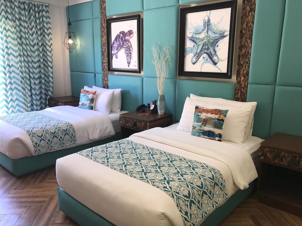 Imagen de la habitación del Hotel Tugawe Cove Resort. Foto 6