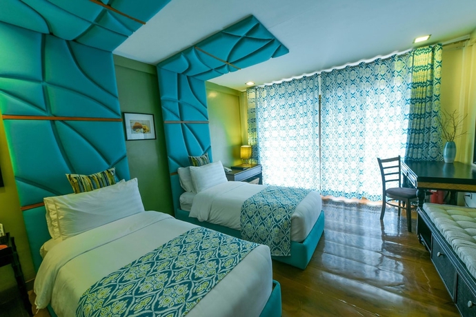 Imagen de la habitación del Hotel Tugawe Cove Resort. Foto 14