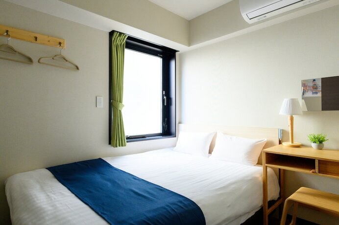Imagen de la habitación del Hotel UENO WOO HOTEL. Foto 17
