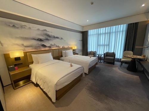 Imagen de la habitación del Hotel Wanda Jin Pingxiang, Luxi. Foto 12