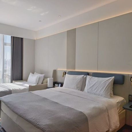 Imagen de la habitación del Hotel Wanda Yuehua Urumqi Railway. Foto 2