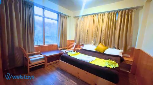 Imagen de la habitación del Hotel Welstays Hadimba Temple. Foto 18