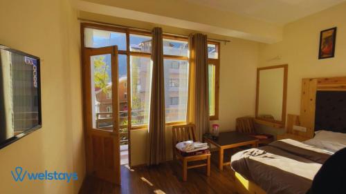 Imagen de la habitación del Hotel Welstays Hadimba Temple. Foto 20