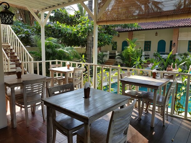 Imagen del bar/restaurante del Hotel White Coconut Cottage. Foto 19