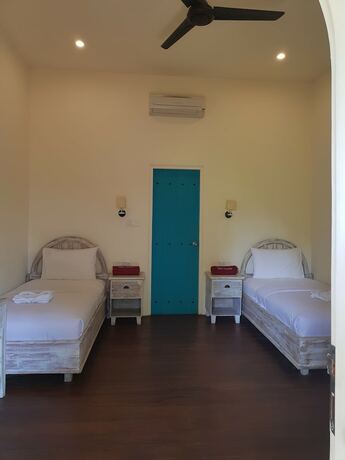 Imagen de la habitación del Hotel White Coconut Cottage. Foto 21