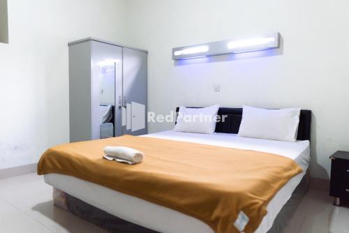 Imagen de la habitación del Hotel Wisma Aini Syariah Mitra RedDoorz. Foto 19