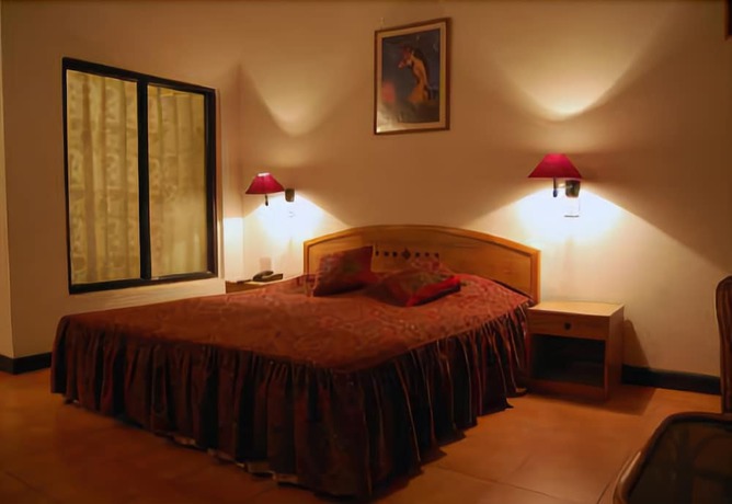 Imagen de la habitación del Hotel Woodsvilla Resort. Foto 10