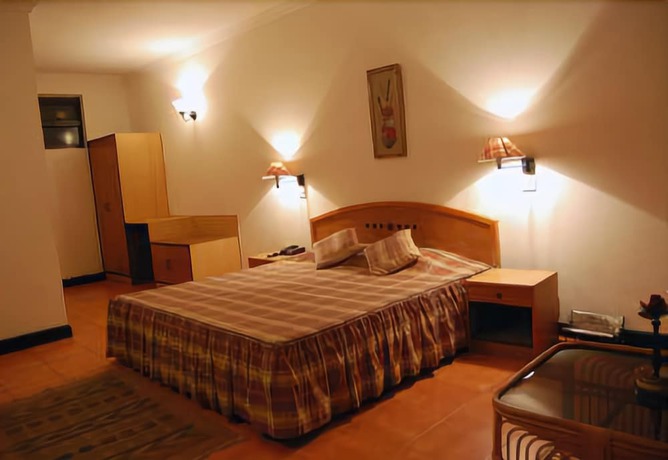 Imagen de la habitación del Hotel Woodsvilla Resort. Foto 11