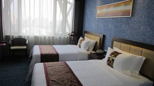 Imagen de la habitación del Hotel Wuhan New Beacon Jinyinhu International. Foto 4