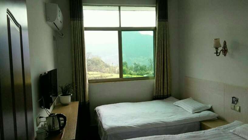 Imagen de la habitación del Hotel Wuyuan Jiangling View Inn. Foto 17