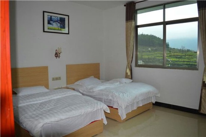 Imagen de la habitación del Hotel Wuyuan Jiangling View Inn. Foto 18