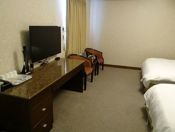 Imagen de la habitación del Hotel Wuzhou. Foto 19