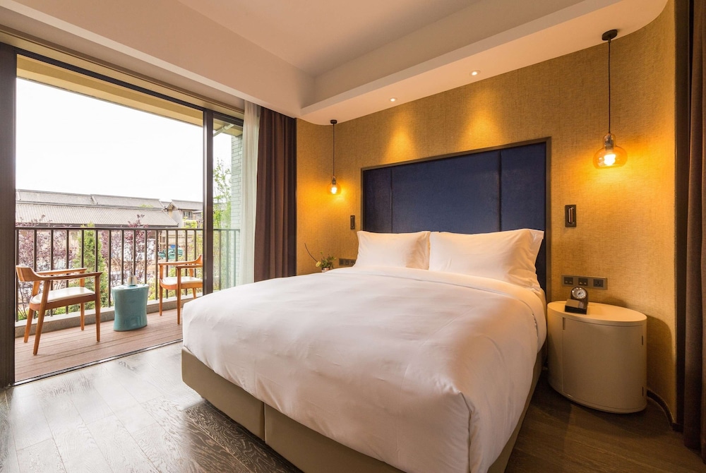 Imagen de la habitación del Hotel Wyndham Grand Royal Hotel Jinlin Lijiang. Foto 5