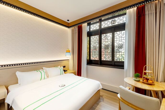 Imagen de la habitación del Hotel XISHU GARDEN INN. Foto 18