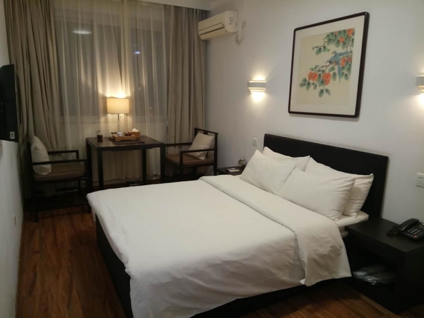 Imagen de la habitación del Hotel Xi, DALIAN. Foto 17