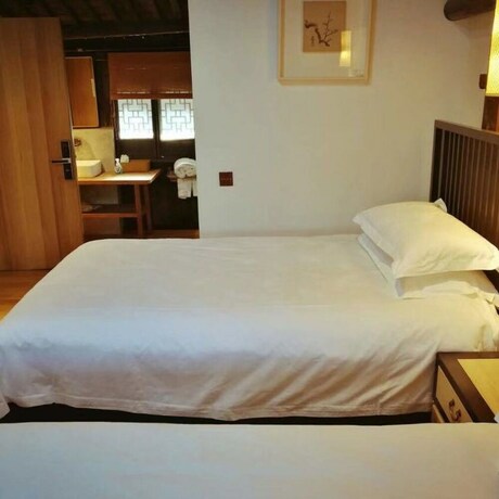 Imagen de la habitación del Hotel Xiaochaguniang Minsu. Foto 20