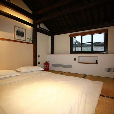 Imagen de la habitación del Hotel Xiaochaguniang Minsu. Foto 23