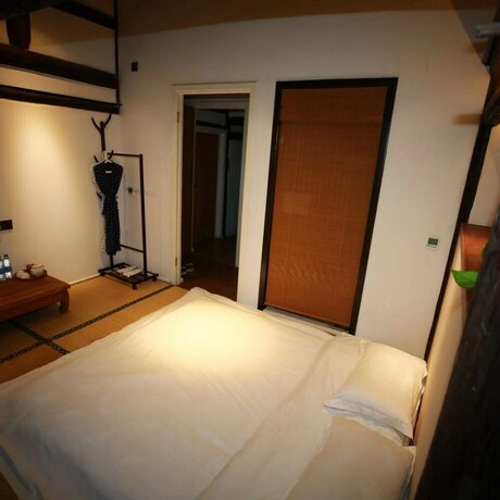 Imagen de la habitación del Hotel Xiaochaguniang Minsu. Foto 35