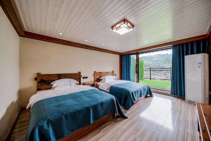 Imagen de la habitación del Hotel Xijiang Village Vision. Foto 4