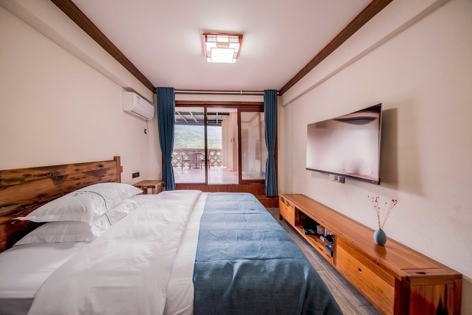 Imagen de la habitación del Hotel Xijiang Village Vision. Foto 11