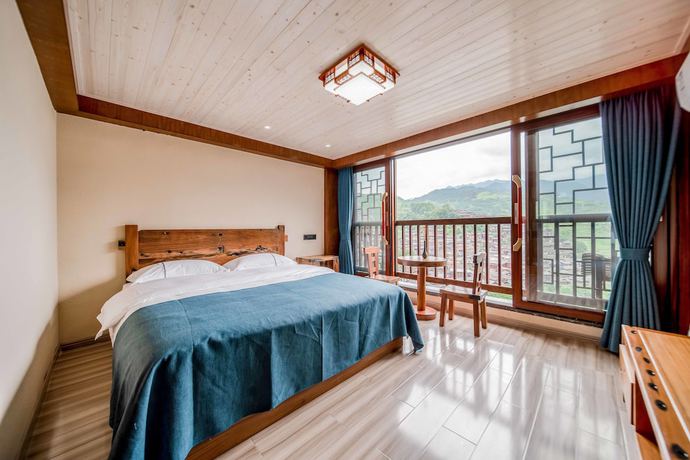 Imagen de la habitación del Hotel Xijiang Village Vision. Foto 14