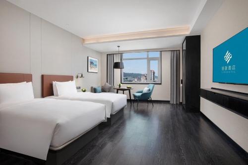 Imagen de la habitación del Hotel Xin\'an Yihao - Xiamen Railway Station Mixc City Store. Foto 20