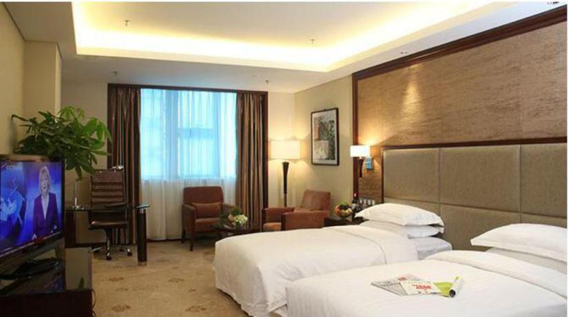 Imagen de la habitación del Hotel Xinjiang Plaza Guest Building. Foto 6